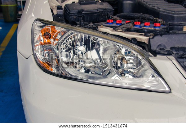 Modern\
polished car front lamp to give a shine. White\
car