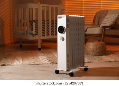 Modern portable electric heater in child room