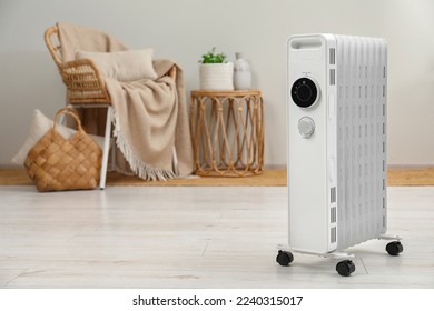 Modern portable electric heater indoors, space for text