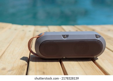 Modern Portable Music Speaker With Voice Assistant Near The Swimming Pool.