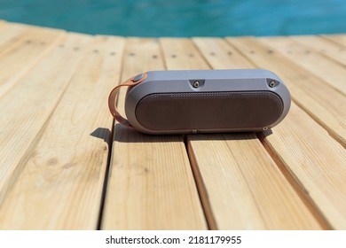 Modern Portable Music Speaker With Voice Assistant Near The Swimming Pool