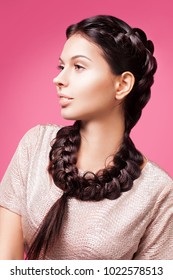 Modern portrait of pretty girl with two pigtails . Fashionable image, the model with braids.