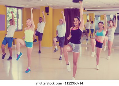 Modern positive active germany males and females dancing excited posing in studio - Shutterstock ID 1122363914
