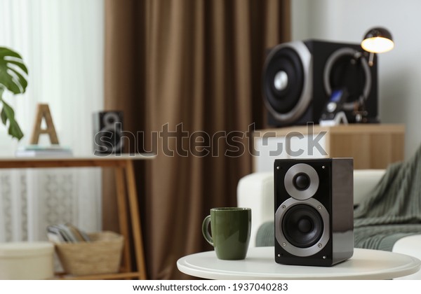 Modern\
powerful audio speaker system in bright\
room
