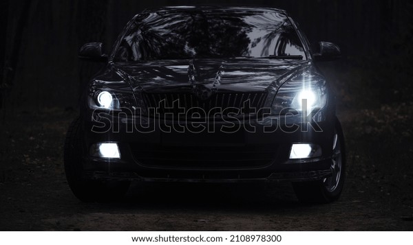 modern\
prestigious car. beautiful car. dark gray color. glowing headlight,\
illuminates on a sports car. in the evening. headlights on in the\
dark. editorial, Ukraine, Kiev, November\
2021