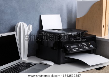 Modern printer, laptop and decor element on white table