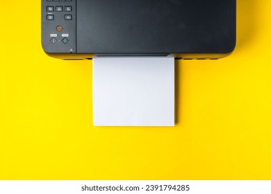Modern printer with paper on yellow background