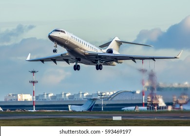 Modern private business jet taking off.