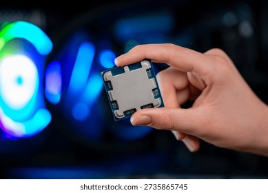 Modern processor chip held in hand inside desktop pc, highlighting computing power, semiconductor design and advanced technology for high performance systems