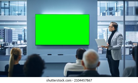 Modern Product Presentation Event: Caucasian Businessman Speaks, Uses Green Chroma Key Screen Wall TV. Press Conference for Group of Diverse Investors, Digital Entrepreneurs - Powered by Shutterstock