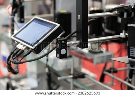 Modern production line with HMI touch screen controller. Selective focus.