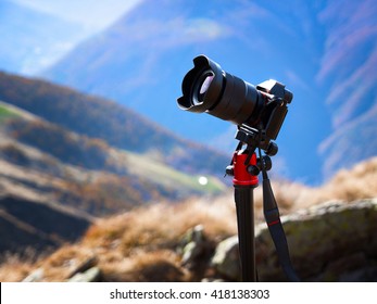 Modern Professional Camera On A Tripod, Outdoor Photography In Wildlife. Mountains Background.