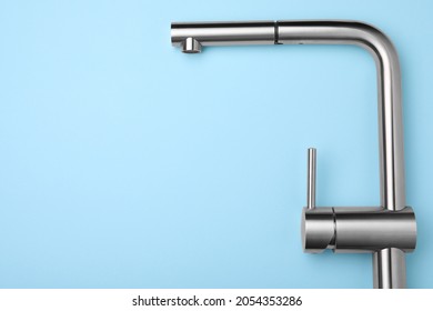 Modern Pull Out Kitchen Faucet On Light Blue Background, Top View. Space For Text