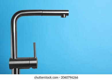 Modern Pull Out Kitchen Faucet On Light Blue Background. Space For Text