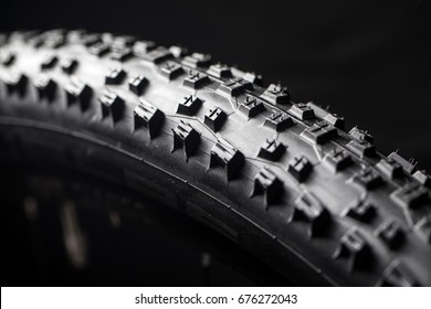 Modern Race Mountain Bike Tyre Isolated On Black Background In A Studio