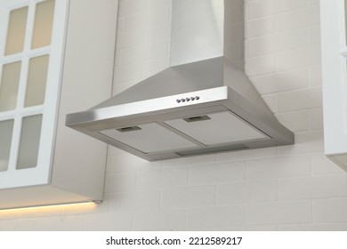 Modern range hood on white brick wall in kitchen - Shutterstock ID 2212589217
