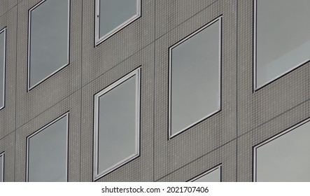 Modern Raw Concrete Office Building With Clean Reflective Glass Rectangle Window Array