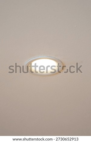 Modern recessed LED ceiling light — minimalist circular fixture emitting soft warm glow, ideal for residential or commercial interior design, showcasing sleek ceiling illumination solution