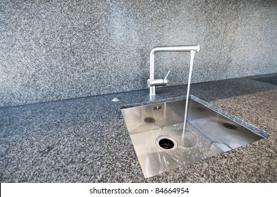 Modern Rectangular Stainless Steel Kitchen Sink On A Granite Worktop