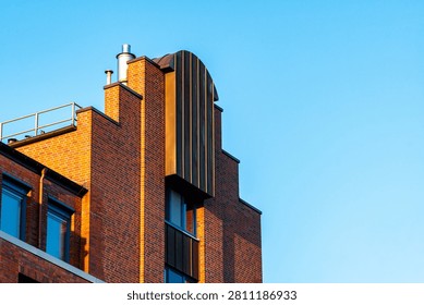 Modern Red Brick Architecture Facade with Copper Girding and Blue Sky Copy Space