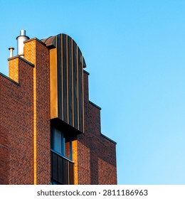 Modern Red Brick Architecture Facade with Copper Girding and Blue Sky Copy Space