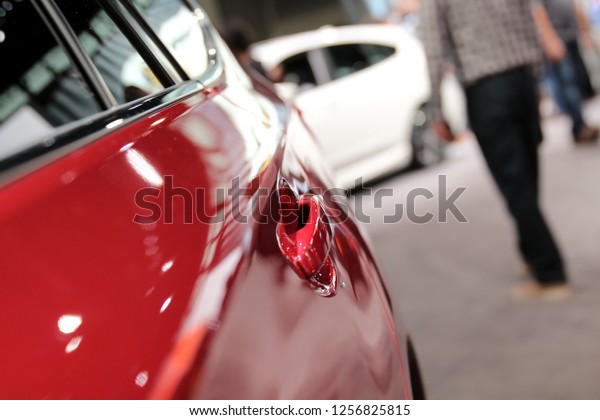 Modern red car. Auto\
handle. Auto show