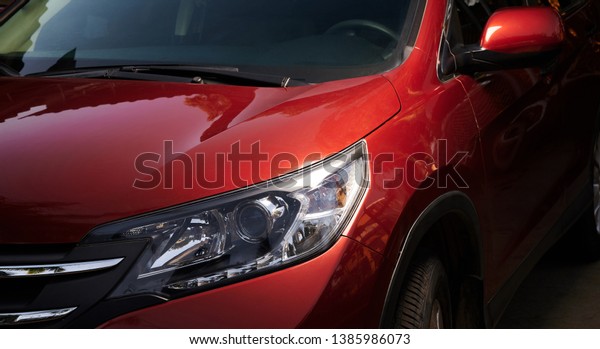 Modern red car\
headlight. Cleaning car\
theme