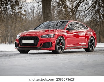 Modern red car, sportcar driving on the road,  city car background