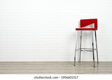 Modern Red Chair On White Brick Wall Background