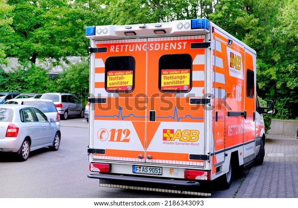 modern Red paramedic ambulance emergency service\
vehicle, medics provide assistance, concept of emergency medical\
care, patient transportation in van to hospital, helping, Frankfurt\
- April 2022