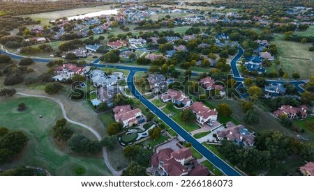modern red rooftops above homes in Suburb Neighborhood with Modern Mansion Homes and Luxury living in Sububia Community outside of Austin , Texas , USA 