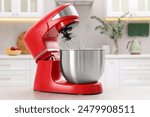 Modern red stand mixer on light gray table in kitchen