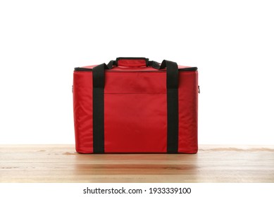 Modern Red Thermo Bag On Wooden Table Against White Background