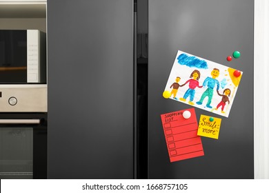 Modern refrigerator and child's drawing  notes   magnets in kitchen