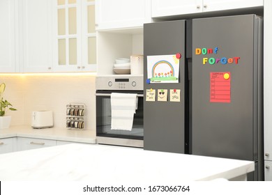 Modern refrigerator and child's drawing  notes   magnets in kitchen  Space for text