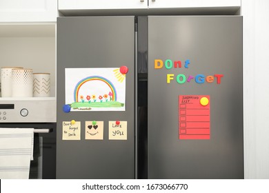 Modern refrigerator and child's drawing  notes   magnets in kitchen