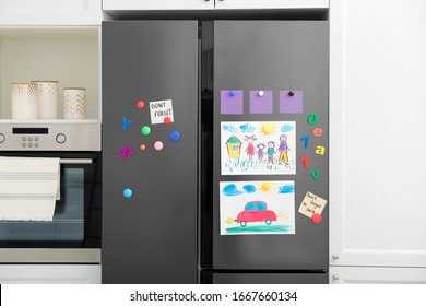 Modern Refrigerator With Child's Drawings, Notes And Magnets In Kitchen