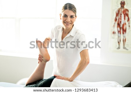 A Modern rehabilitation physiotherapy woman worker with client
