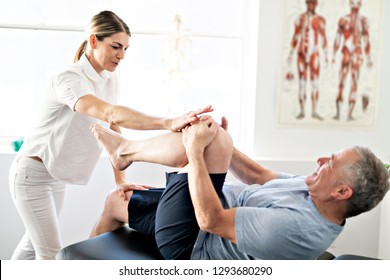 A Modern Rehabilitation Physiotherapy Worker With Senior Client