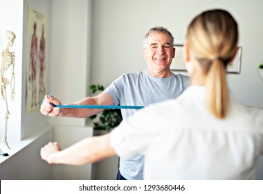 A Modern rehabilitation physiotherapy worker with senior client - Shutterstock ID 1293680446