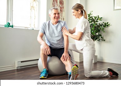 A Modern Rehabilitation Physiotherapy Worker With Senior Client