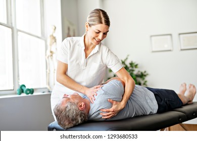 A Modern Rehabilitation Physiotherapy Worker With Senior Client