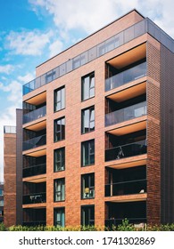 Modern Residential Apartment And Flat Building Exterior. Part Of New Luxury House And Home Complex. City Real Estate Property And Condo Architecture. Copy Space. Blue Sky