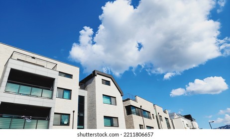 A Modern Residential Complex And A Clear Blue Sky