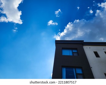 A Modern Residential Complex And A Clear Blue Sky