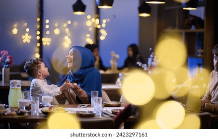 In a modern restaurant, an Islamic couple and their children joyfully await their iftar meal during the holy month of Ramadan, embodying familial harmony and cultural celebration amidst the - Powered by Shutterstock