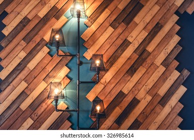 Modern Restaurant With Rustic Decorative Elements. Interior Design Details With Lamps And Bulb Lights. Wooden Wall Decoration With Vintage Looking Lights