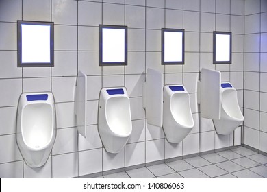 modern restroom interior with urinal row and frame for advertisement