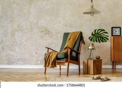 Modern retro composition of living room interior with design armchair, cube, tropical leaf, plaid, carpet, decoration and elegant presonal accessories in wabi sabi concept.