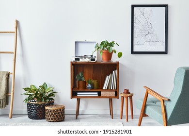 Modern retro composition of living room interior with design wooden cabinet, stylish armchair, mock up poster map, plants, vinyl recorder, books and personal accessories in home decor. Template. - Shutterstock ID 1915281901